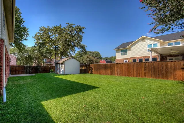 a front view of a house with yard and green space