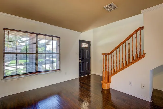a view of an entryway with wooden floor