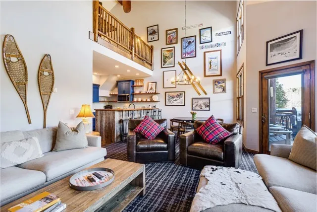 a living room with furniture or couch and a chandelier