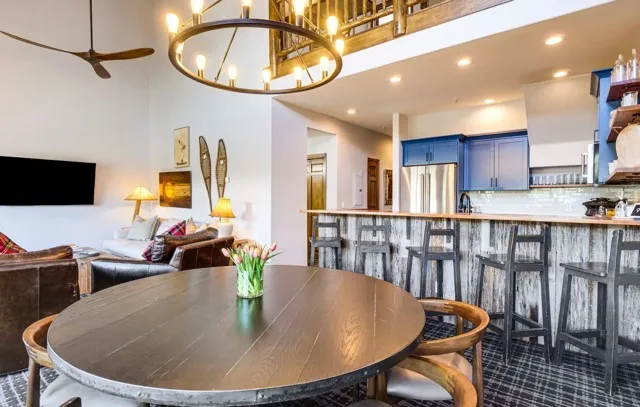 a bedroom with a bed and a lamp on a dresser