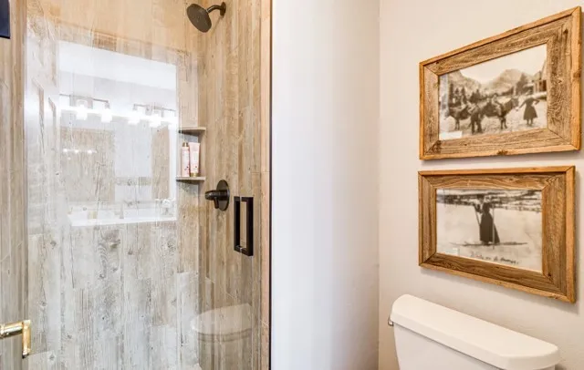 a bedroom with a large bed and a flat tv screen on dresser