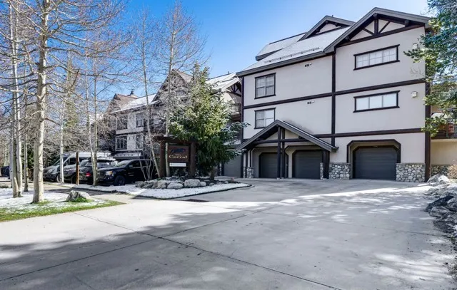 a view of a house with a yard and garage