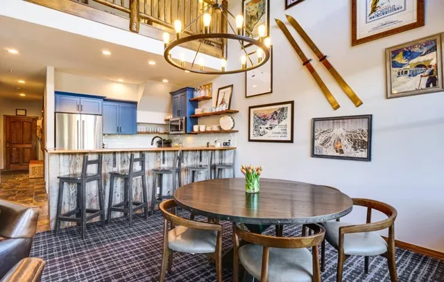 a view of a dining room with furniture and a chandelier
