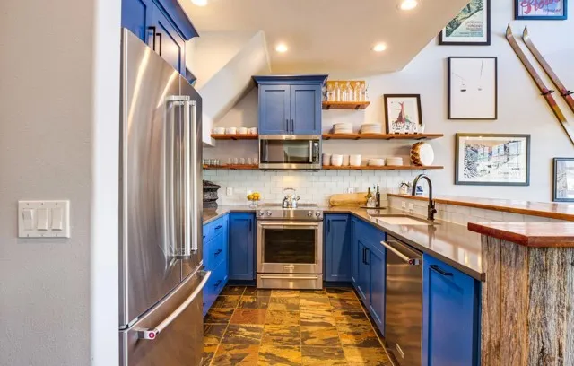 a kitchen with stainless steel appliances granite countertop a stove and a sink