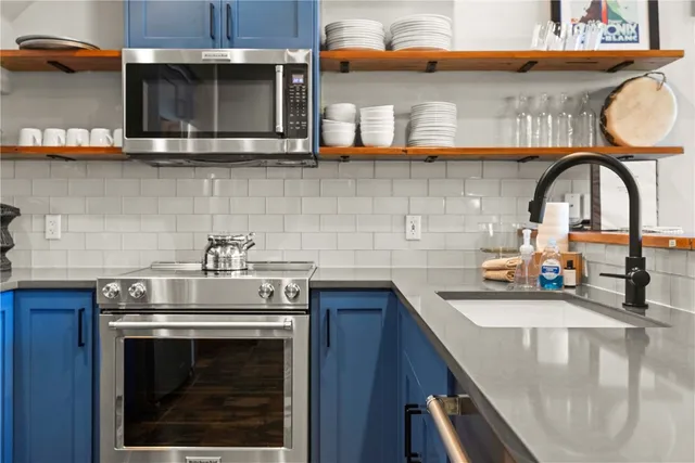 a kitchen with stainless steel appliances granite countertop a sink and cabinets