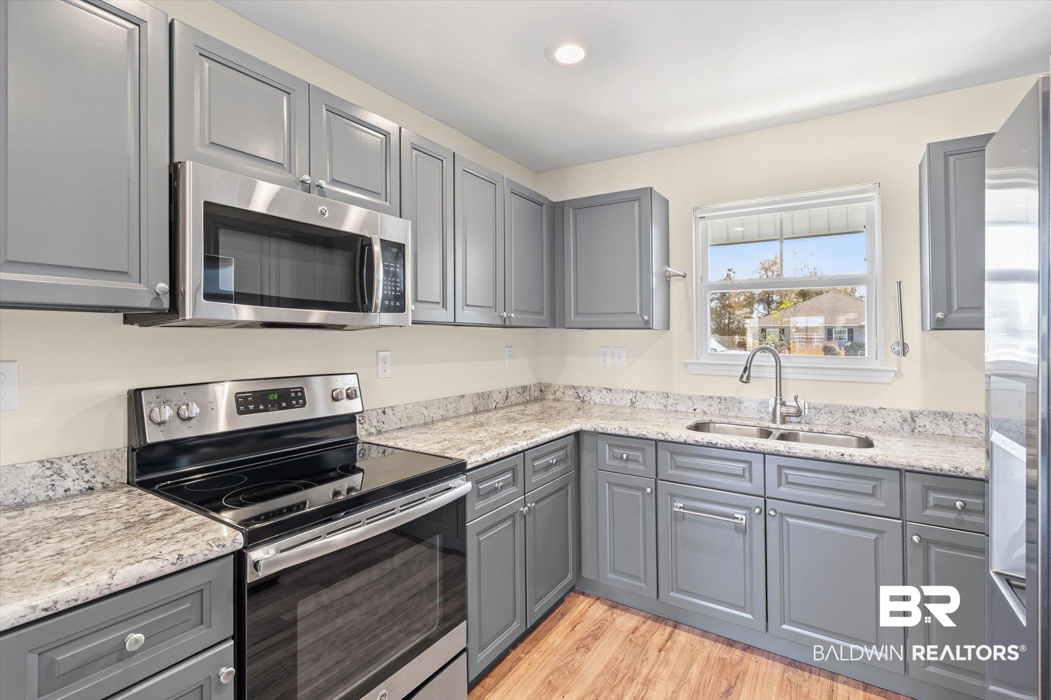 919 Sailor Circle Foley, AL 36535 - Photo 7 of 24 Kitchen with gray cabinets, stainless steel appliances, light stone countertops, and recessed lighting