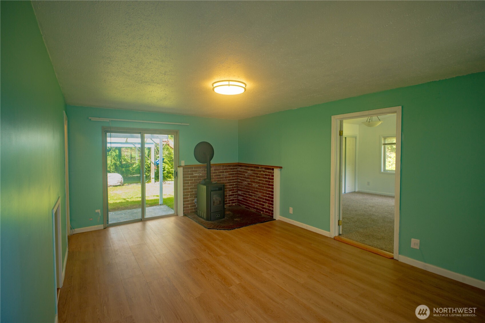 89 Slab Camp Road Sequim, WA 98382 - Photo 16 of 40 a view of an empty room with wooden floor and a window