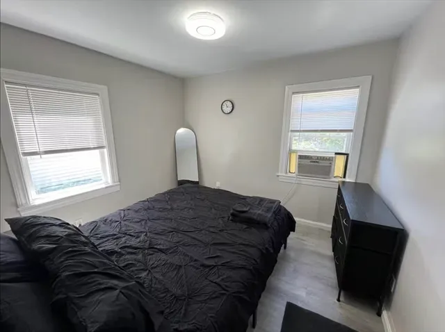 a bedroom with a bed and a window