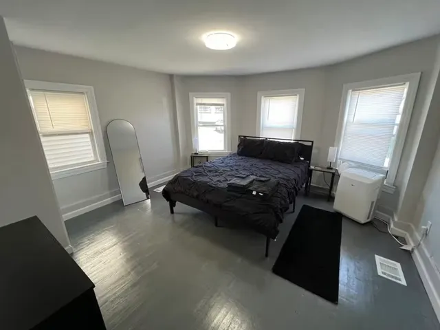 a bedroom with a bed and a window