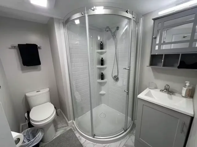 a bathroom with a toilet a sink and shower