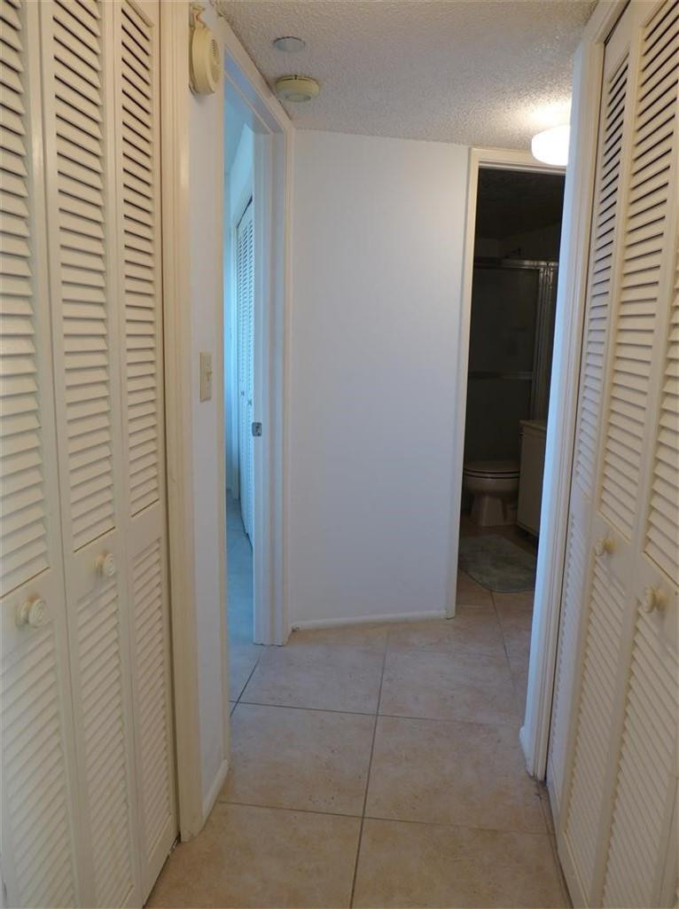 3095 North Course Drive, Unit 1005 Pompano Beach, FL 33069 - Photo 18 of 32 Hall to Guest suite