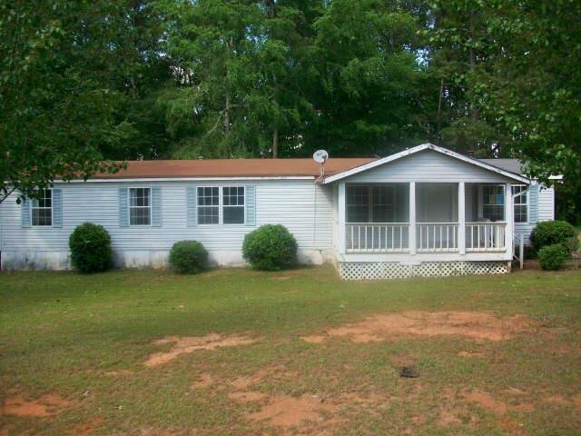 682 Manning Gin Road Monroe, GA 30656 - Photo 1 of 1 a front view of a house with a garden