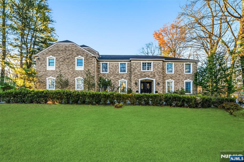 27 Pine Hill Road Old Tappan, NJ 07675 - Photo 2 of 50 a front view of a house with a garden