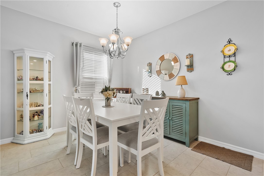 6187 Red Maple Manor Vero Beach, FL 32966 - Photo 9 of 31 a view of a dining room with furniture and chandelier