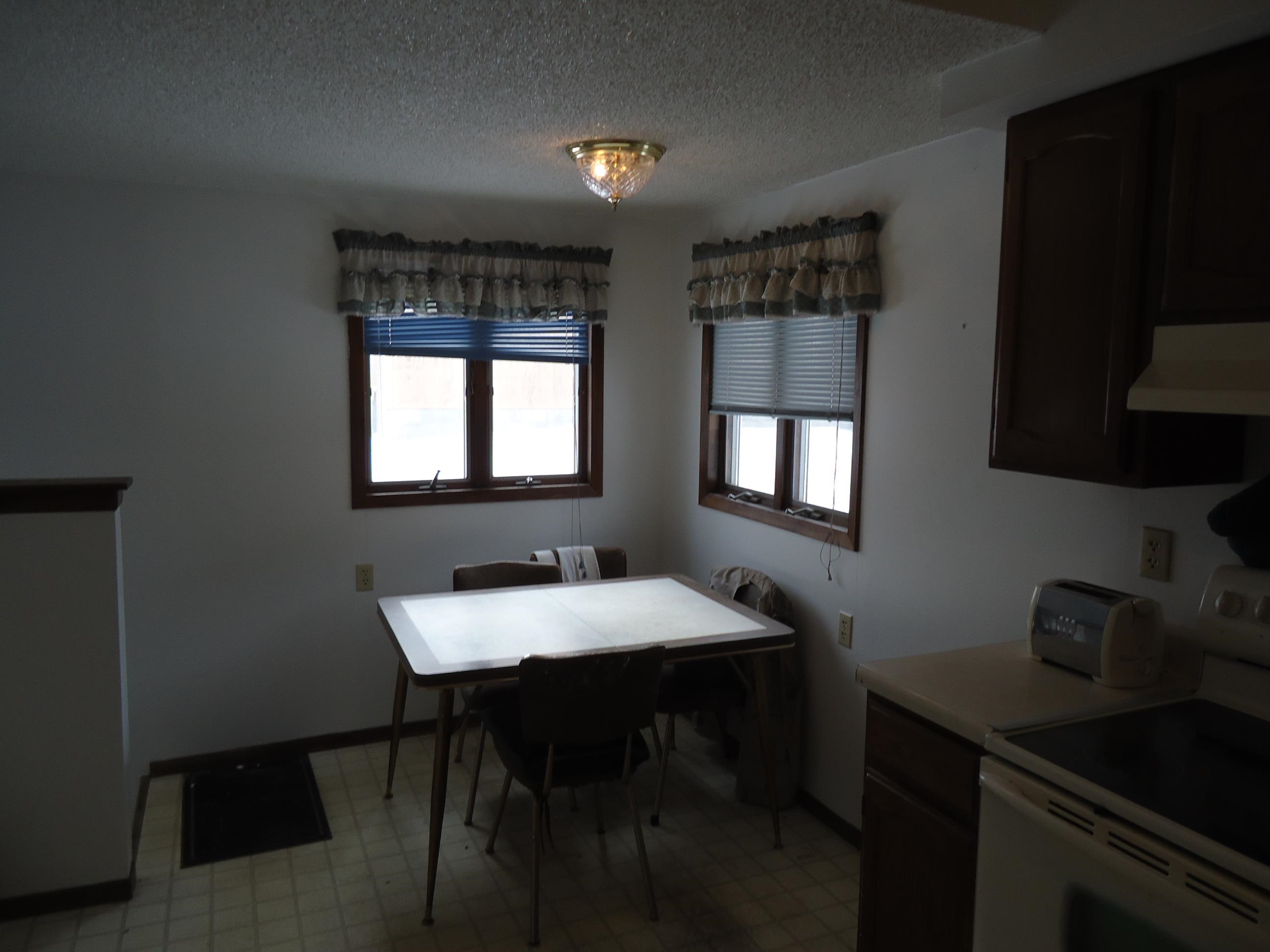 17 3rd Street Southeast Chisholm, MN 55719 - Photo 13 of 28 Dining room with light flooring, plenty of natural light, and a textured ceiling