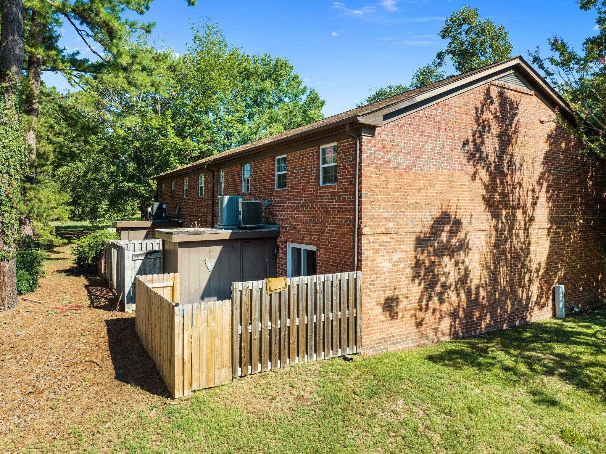 1209 Manassas Court, Unit B Raleigh, NC 27609 - Photo 34 of 34 a view of a house with a wooden fence