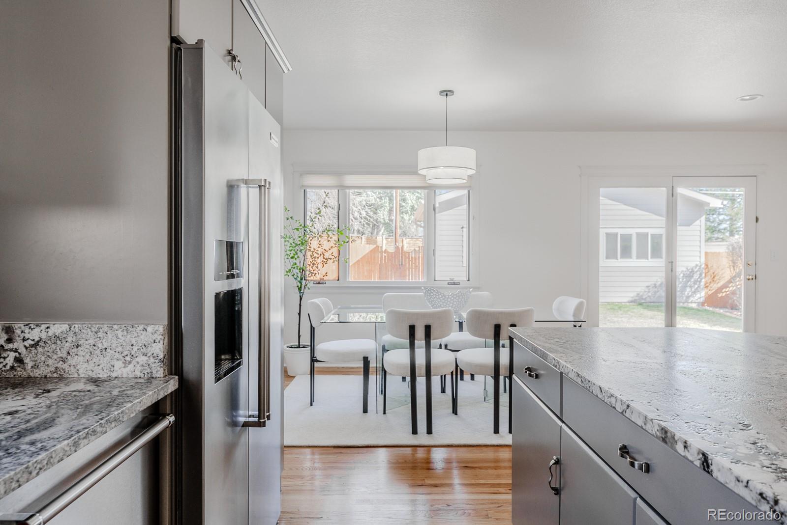 1835 Columbine Avenue Boulder, CO 80302 - Photo 12 of 40 a view of a kitchen with kitchen island granite countertop a table chairs in it and wooden floors