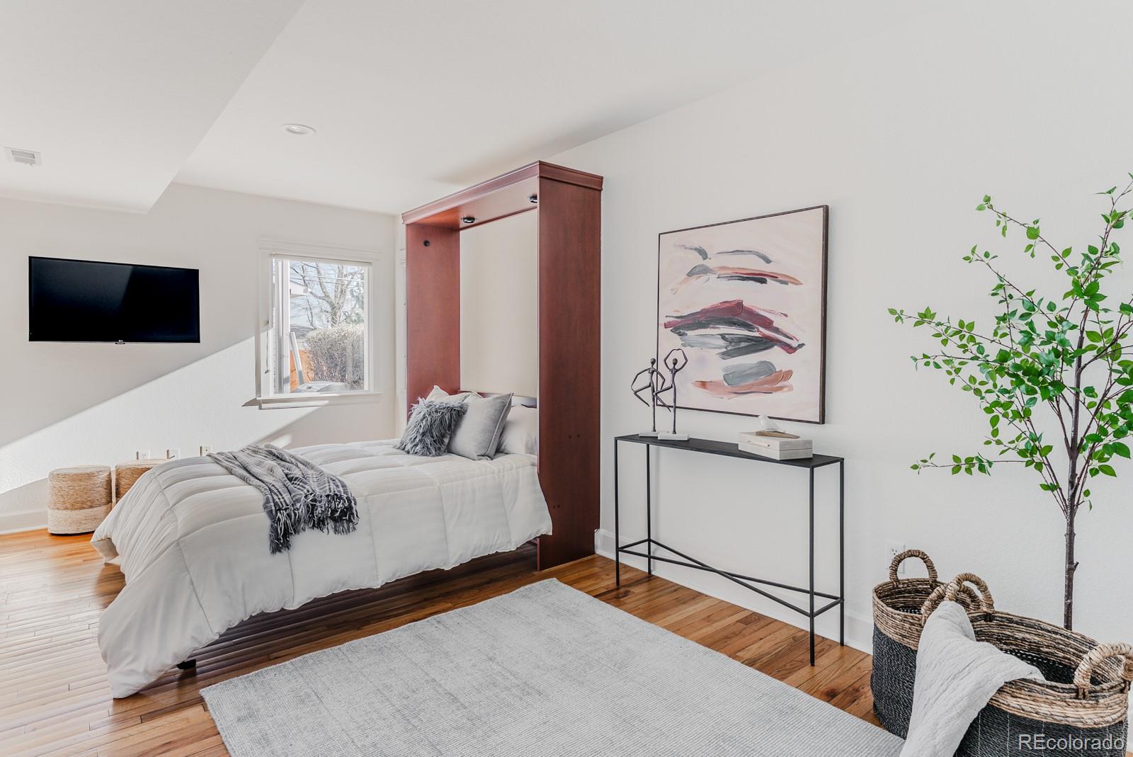 1835 Columbine Avenue Boulder, CO 80302 - Photo 18 of 40 a bedroom with a bed and a flat screen tv
