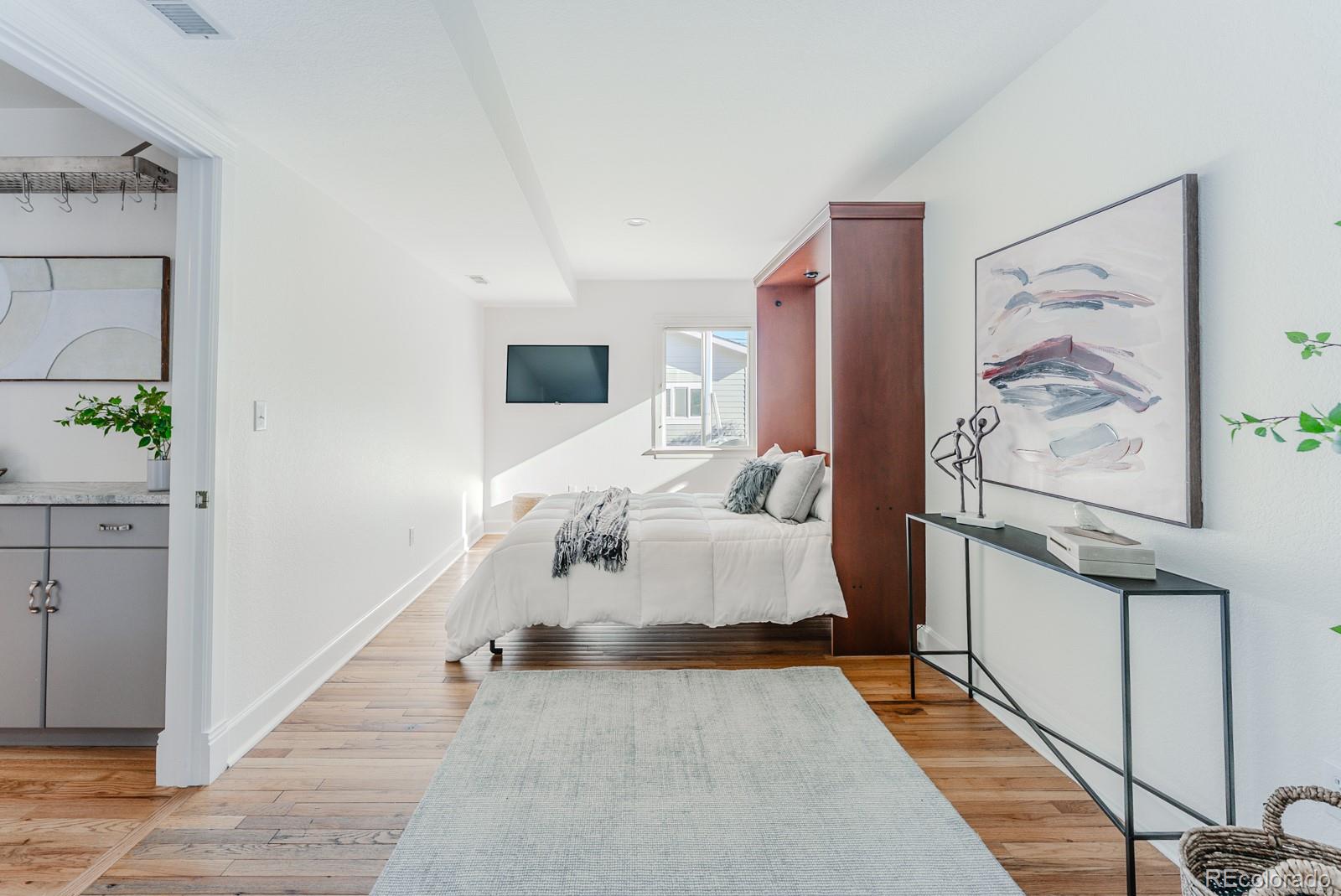 1835 Columbine Avenue Boulder, CO 80302 - Photo 19 of 40 a bed room with a bed and painting on the wall
