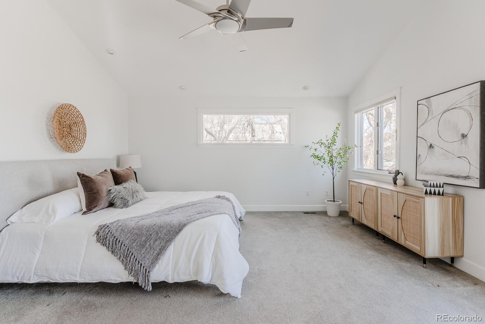 1835 Columbine Avenue Boulder, CO 80302 - Photo 23 of 40 a bedroom with a bed and a chandelier