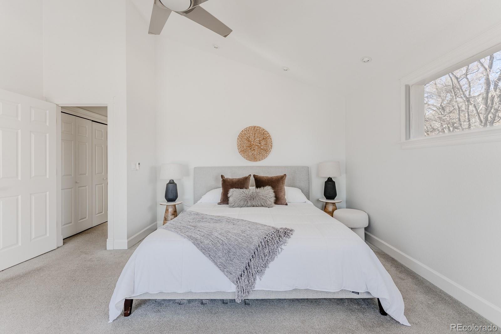 1835 Columbine Avenue Boulder, CO 80302 - Photo 24 of 40 a bedroom with a bed and chandelier