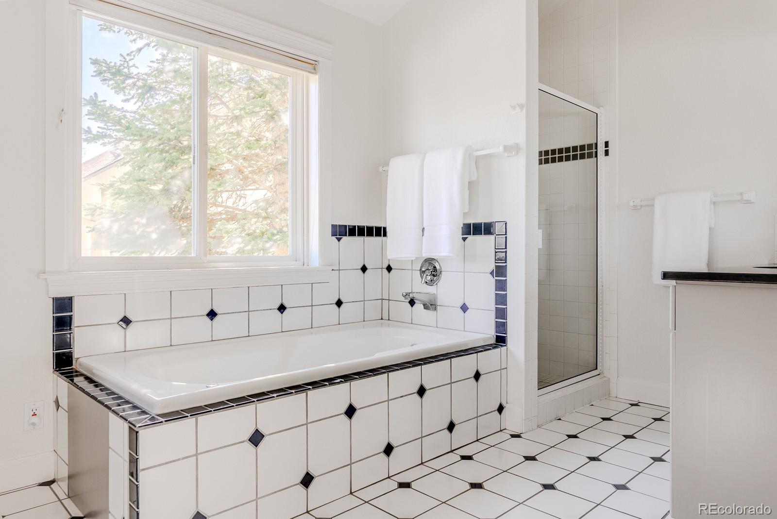 1835 Columbine Avenue Boulder, CO 80302 - Photo 28 of 40 a bathroom with a granite countertop sink a mirror and a bathtub