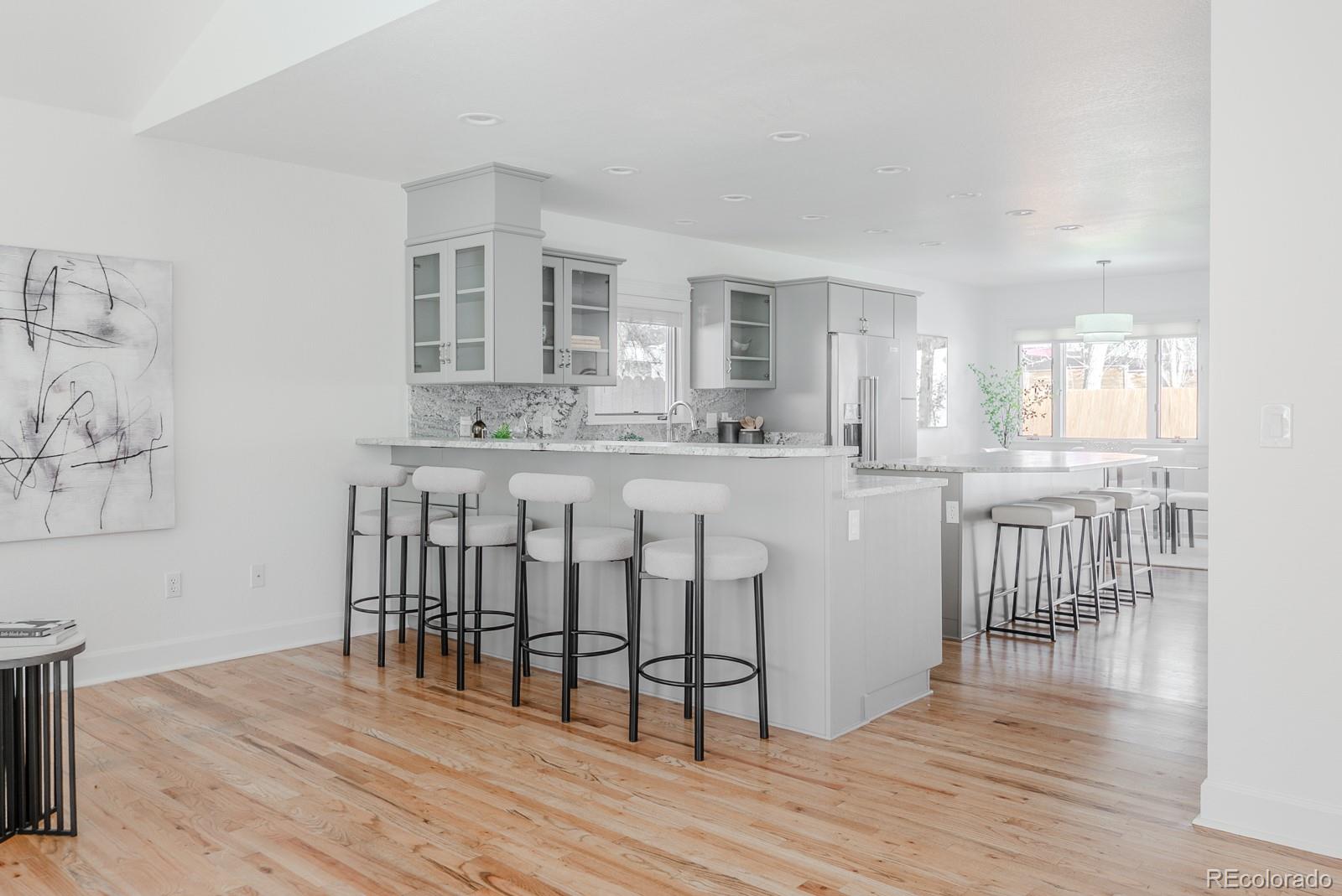 1835 Columbine Avenue Boulder, CO 80302 - Photo 6 of 40 a kitchen with kitchen island granite countertop a dining table chairs cabinets and wooden floor