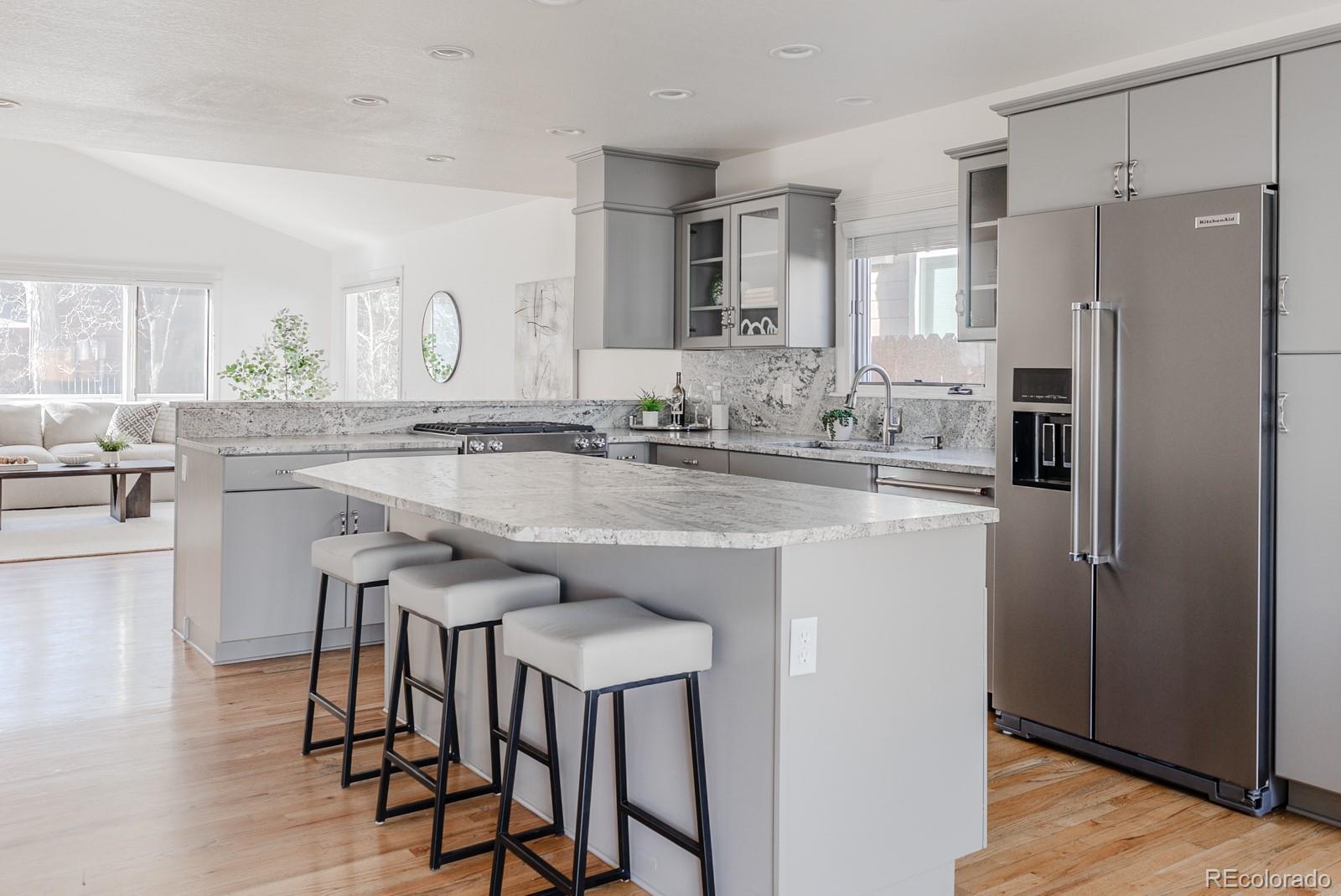 1835 Columbine Avenue Boulder, CO 80302 - Photo 7 of 40 a kitchen with stainless steel appliances granite countertop a table chairs refrigerator and sink