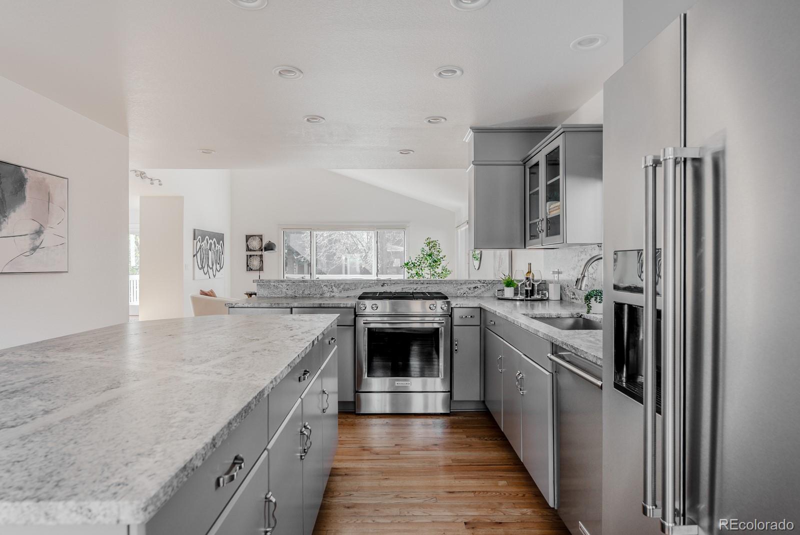 1835 Columbine Avenue Boulder, CO 80302 - Photo 8 of 40 a kitchen with stainless steel appliances granite countertop hardwood floor sink stove and refrigerator