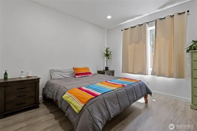 a bedroom with a bed and a window