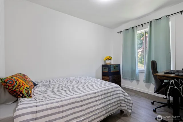 a bedroom with a bed and a mirror