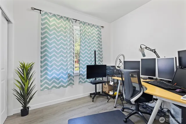 a view of a workspace with furniture and a flat screen tv