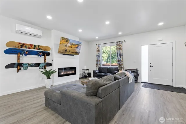a living room with furniture a fireplace and a flat screen tv