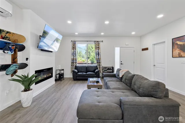 a living room with furniture a fireplace and a potted plant
