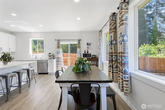 a view of a dining room with furniture window and wooden floor