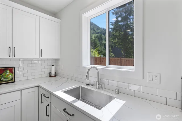 a kitchen with a sink and cabinets