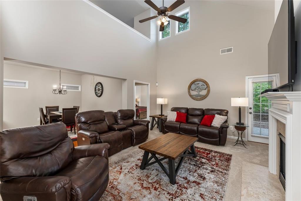 113 Tyson Woods Road Acworth, GA 30102 - Photo 6 of 37 a living room with furniture a fireplace and a window