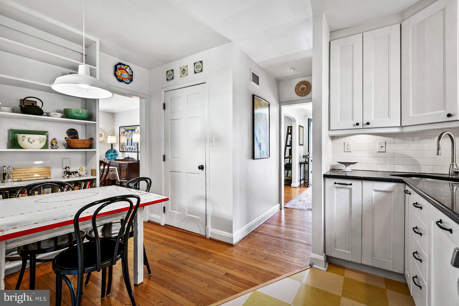 620 Overbrook Road Baltimore, MD 21212 - Photo 15 of 53 a kitchen with stainless steel appliances granite countertop a dining table chairs refrigerator and sink