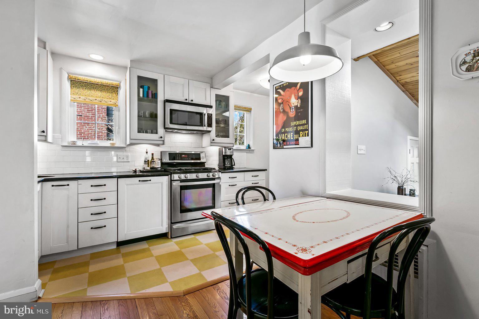 620 Overbrook Road Baltimore, MD 21212 - Photo 16 of 53 a kitchen with a table a stove and a microwave