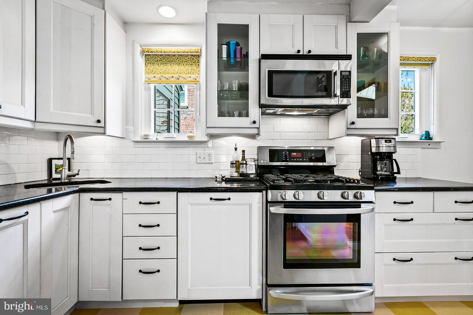 620 Overbrook Road Baltimore, MD 21212 - Photo 18 of 53 a kitchen with stainless steel appliances granite countertop a stove and a microwave