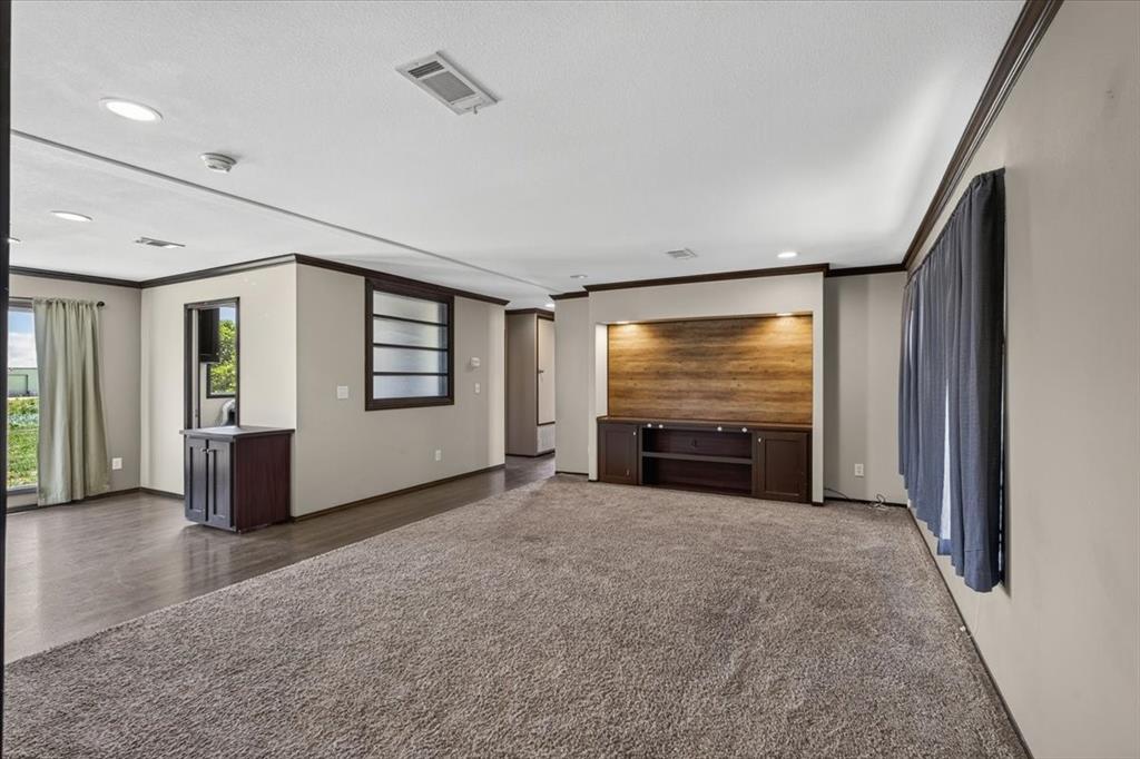 1129 Ragsdale Street Terrell, TX 75160 - Photo 3 of 29 Living space with built ins and wood accent on the wall