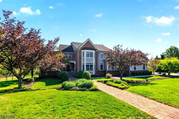a front view of a house with a yard and potted plants