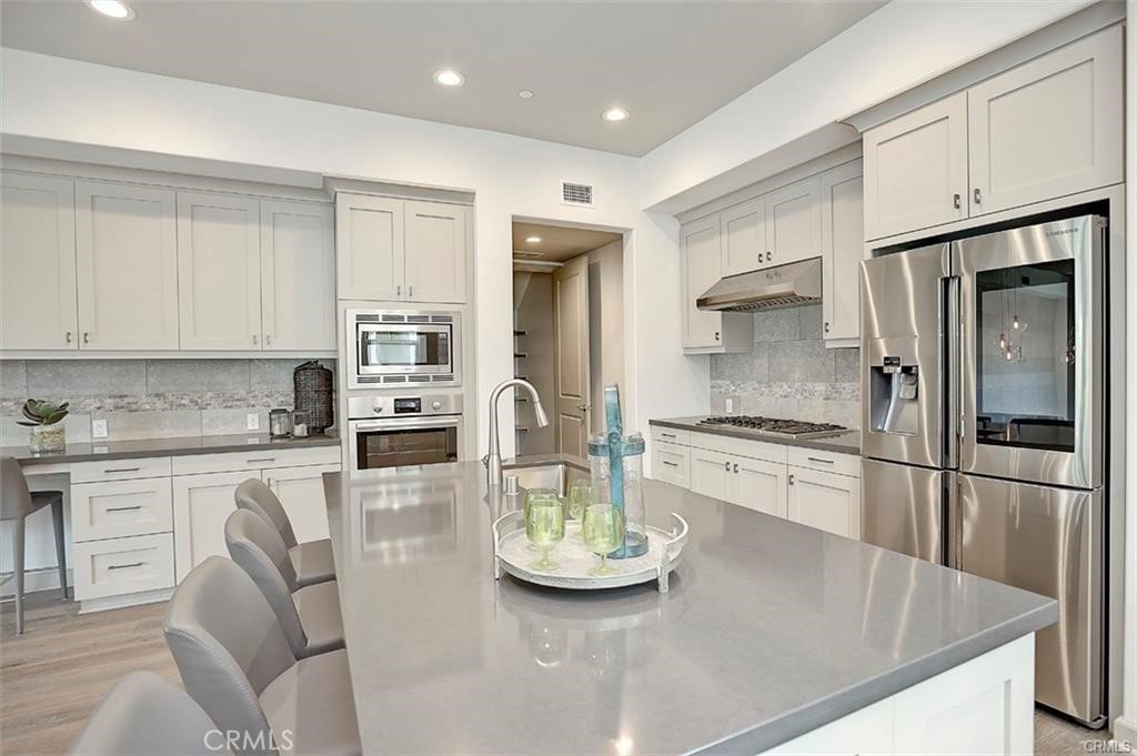 115 Fixie Irvine, CA 92618 - Photo 12 of 29 a kitchen with stainless steel appliances granite countertop a stove refrigerator sink and cabinets