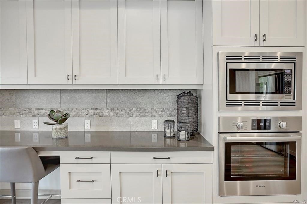 115 Fixie Irvine, CA 92618 - Photo 14 of 29 a kitchen with granite countertop white cabinets and appliances