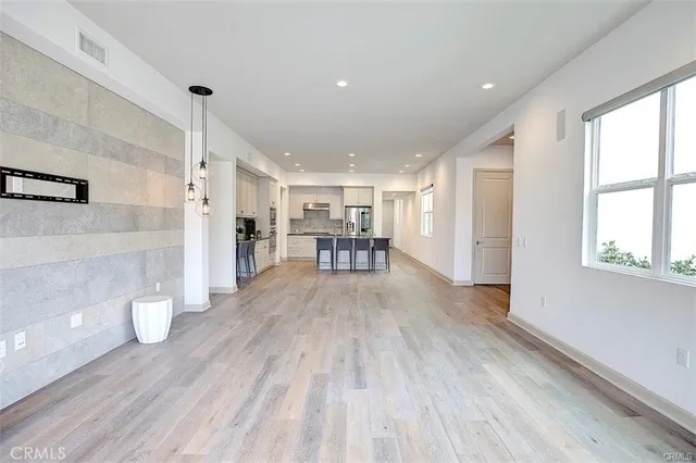 a large kitchen with cabinets and wooden floor
