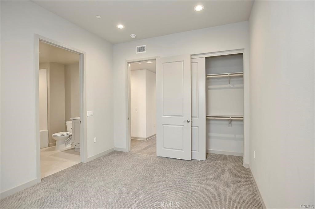 115 Fixie Irvine, CA 92618 - Photo 23 of 29 a view of bathroom with a toilet a sink and a mirror