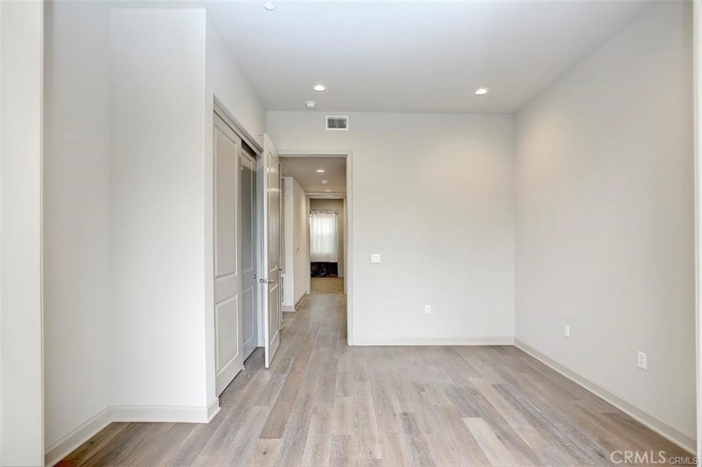 115 Fixie Irvine, CA 92618 - Photo 25 of 29 a view of a hallway with wooden floor