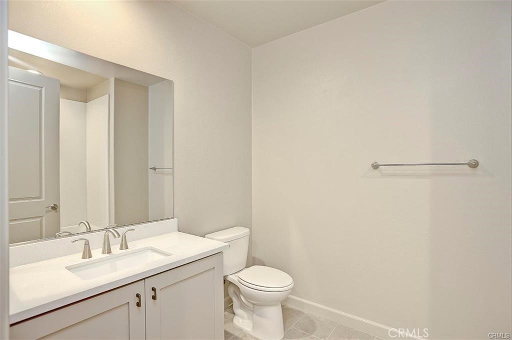 115 Fixie Irvine, CA 92618 - Photo 27 of 29 a bathroom with a sink a toilet and a mirror