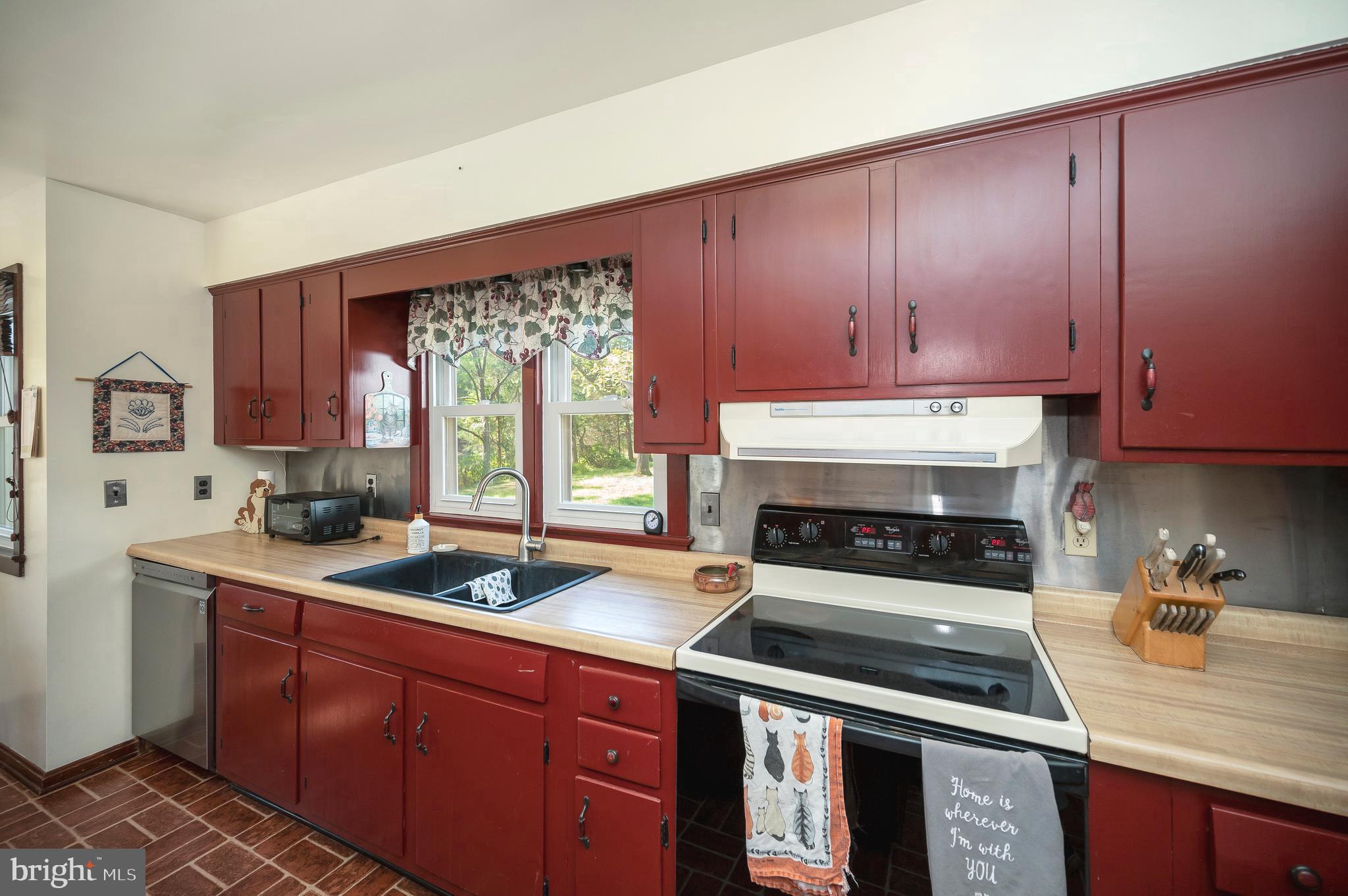 31934 Indiantown Road Locust Grove, VA 22508 - Photo 22 of 60 a kitchen with wooden cabinets and a stove top oven