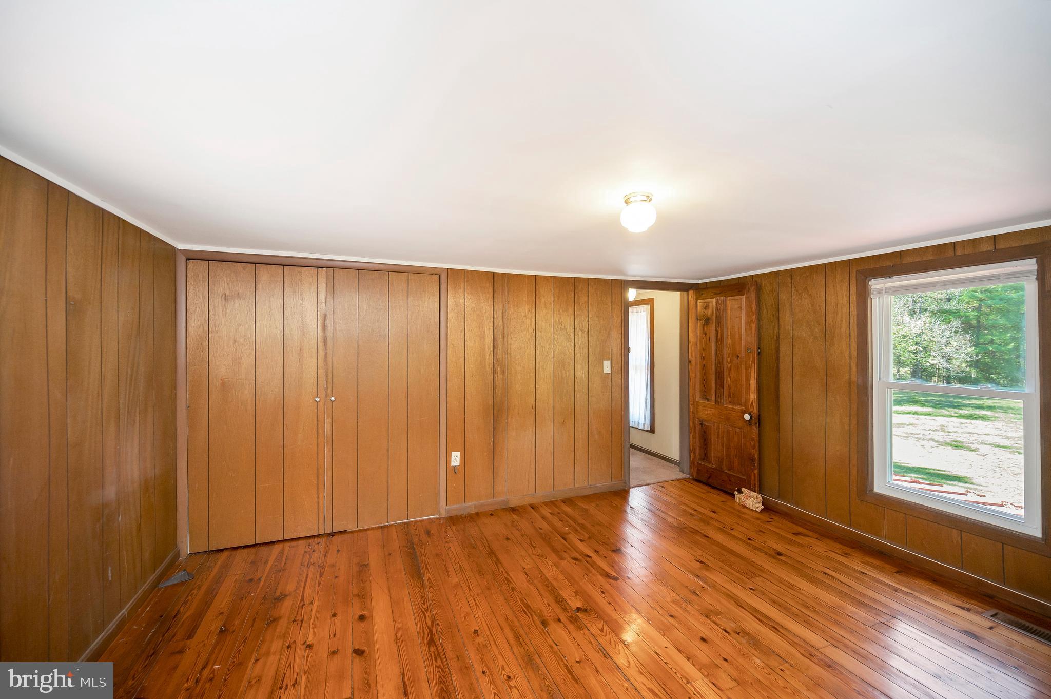 31934 Indiantown Road Locust Grove, VA 22508 - Photo 31 of 60 a view of an empty room with wooden floor and a window